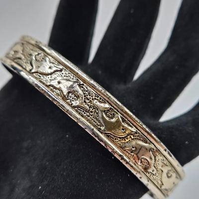 LOT 27: Three Silver-tone Cuff Bracelets and one Magnetic Closure Braided Rope-like Bracelet