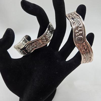 LOT 27: Three Silver-tone Cuff Bracelets and one Magnetic Closure Braided Rope-like Bracelet