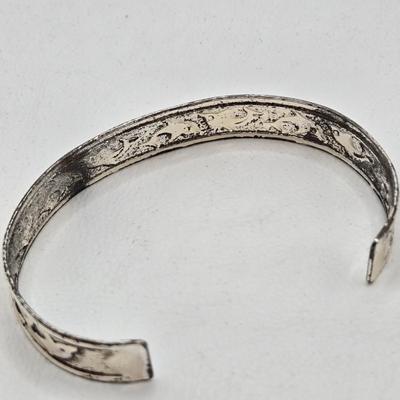 LOT 27: Three Silver-tone Cuff Bracelets and one Magnetic Closure Braided Rope-like Bracelet