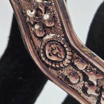 LOT 27: Three Silver-tone Cuff Bracelets and one Magnetic Closure Braided Rope-like Bracelet