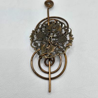 LOT 29: Three Hand-Crafted Metal Hair Accessories