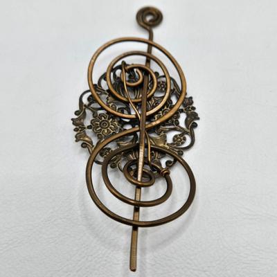 LOT 29: Three Hand-Crafted Metal Hair Accessories