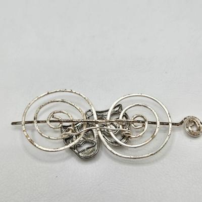 LOT 29: Three Hand-Crafted Metal Hair Accessories