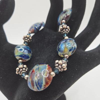 LOT 31: Beautiful Multi-Colored Bead Bracelet, Green Bead and Silver Shamrock Charm Bracelet, and Silver-tone Abalone Bracelet