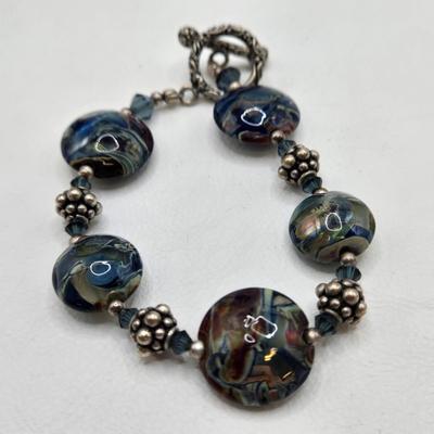 LOT 31: Beautiful Multi-Colored Bead Bracelet, Green Bead and Silver Shamrock Charm Bracelet, and Silver-tone Abalone Bracelet