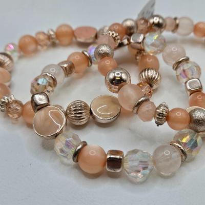 LOT 40: Gold-tone and Rose Colored Gemstone Necklace, Salmon Colored Necklace w/ Matching Earrings, 2 Bracelet and Earring Sets, and...