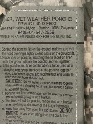 Two wet weather, ponchos, shovel, bag, and sleeping mat