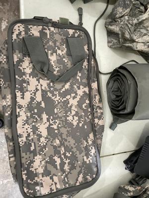 Two wet weather, ponchos, shovel, bag, and sleeping mat