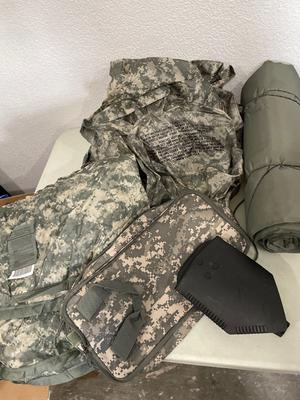 Two wet weather, ponchos, shovel, bag, and sleeping mat