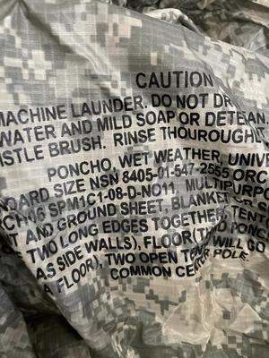 Two wet weather, ponchos, shovel, bag, and sleeping mat