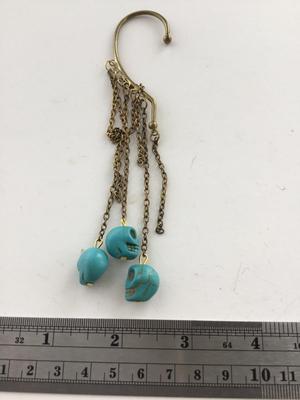 Gold tone blue skull dangle over ear jewelry