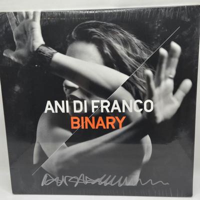 LOT 11: New in Sealed Plastic Signed Ani Di Franco Album, T-Shirt, and Lyrics Booklet