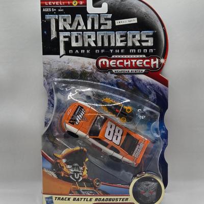 LOT 43: NIB Holiday Optimus Prime and Transformers Dark of the Moon Mechtech Weapons System