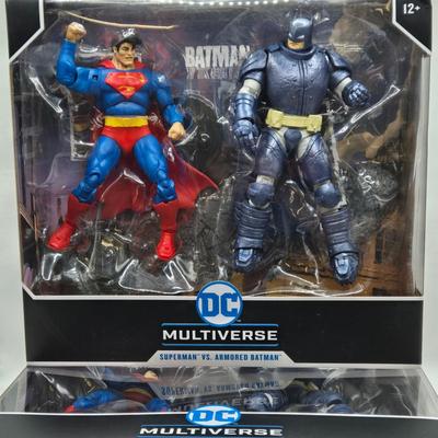 LOT 79: 2 Sets of DC Multiverse Superman vs. Batman NIB