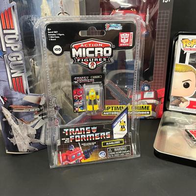 LOT 190: Big Lot of Transformers Toys and Collectibles, Top Gun Maverick, Funko GI Joe Crossover Lunchbox Set and More