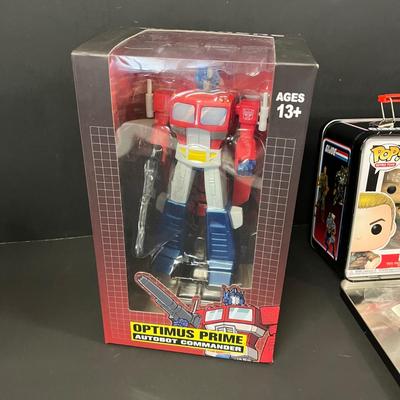 LOT 190: Big Lot of Transformers Toys and Collectibles, Top Gun Maverick, Funko GI Joe Crossover Lunchbox Set and More