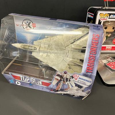 LOT 190: Big Lot of Transformers Toys and Collectibles, Top Gun Maverick, Funko GI Joe Crossover Lunchbox Set and More