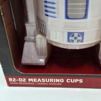 LOT 194: NIB Star Wars Funko Pops Including The Bad Batch Set and 2 Iden Versio, R2-D2 Measuring Cup Set, and Millennium Falcon...