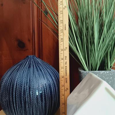 LOT 14: Contemporary Home Decor Including Crate & Barrel Vase, Rae Dunn Travel Fund Bank, and Scott Living Artificial Grass Plant and...