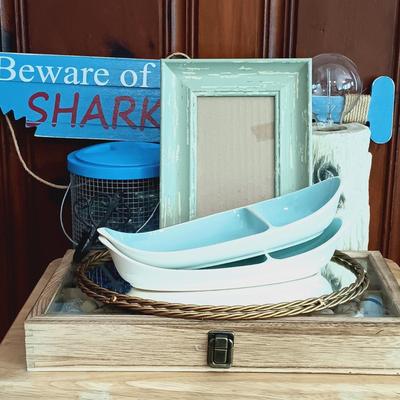 LOT 24: Nautical Collection: Framed Seashells, Boat Shaped Ceramic Dishes, Faux Log Lamp, Crab Trap and Wall Decor