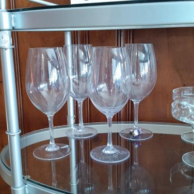 LOT 25: Metal and Glass Serving Cart with Glasses, Shaker, Tablecloths, Corkcicle Wine Pourer, Whimsical Straws and More