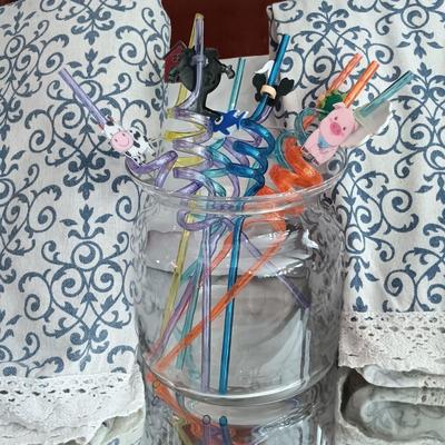LOT 25: Metal and Glass Serving Cart with Glasses, Shaker, Tablecloths, Corkcicle Wine Pourer, Whimsical Straws and More