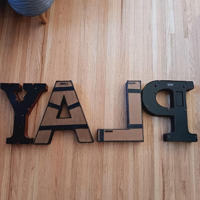 LOT 38: Bin Full of Porch Decor and More Featuring Stainless Steel Umbrella Holder and Umbrellas, Metal Letters that Spell PLAY, Wooden...