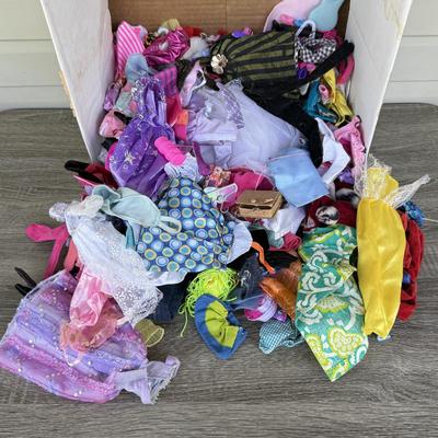 LOT 140P: Box of Barbie Sized Clothing & Accessories