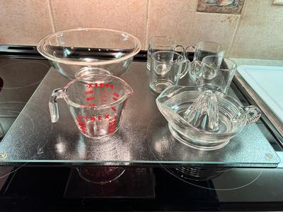 CLEAR GLASS KITCHEN MEASURING CUP, JUICER, JUICE GLASSES, MIXING BOWL, AND CUTTING BOARD