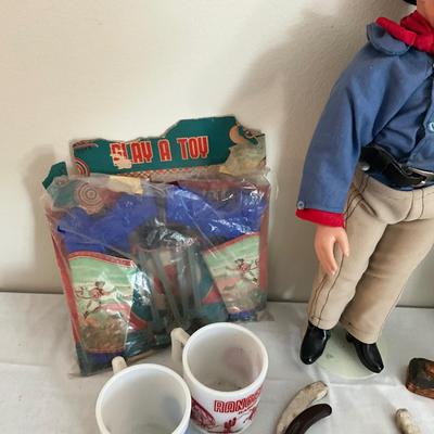 D987 John Wayne Porcelain Doll with Sand Pail, Belt, Mugs, Toys