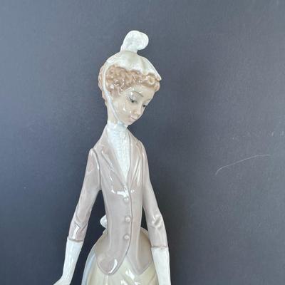 Lladro figurine 4761 "Woman with Umbrella and Dog."