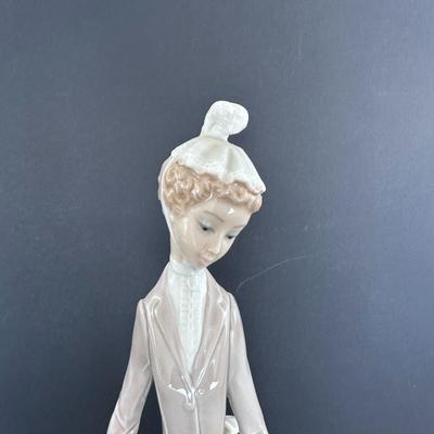 Lladro figurine 4761 "Woman with Umbrella and Dog."