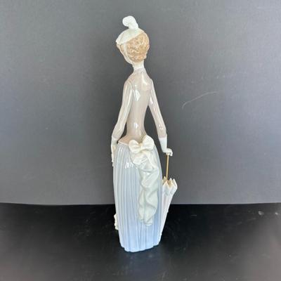 Lladro figurine 4761 "Woman with Umbrella and Dog."