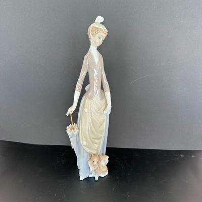 Lladro figurine 4761 "Woman with Umbrella and Dog."