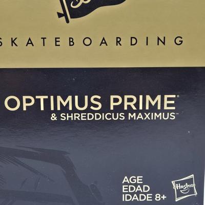 LOT 17: Transformers primitive Skateboarding Optimus Prime & Shreddicus Maximus NIB