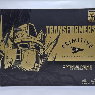 LOT 17: Transformers primitive Skateboarding Optimus Prime & Shreddicus Maximus NIB