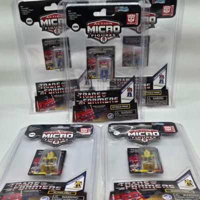 LOT 28: World's Smallest Action Micro Figures/ 3 Optimus Prime and 2 Bumblebees NIP