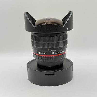 LOT 56: Rokinon 8mm 1:3.5 f/3.5 Fisheye CSII Lens w/ Hood (for Nikon Cameras)
