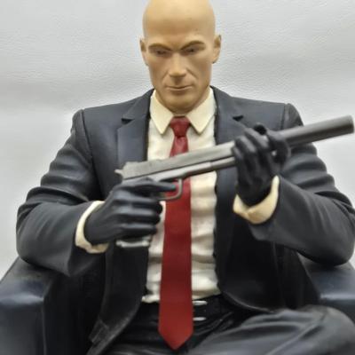 LOT 75: Hitman Agent 47 Statue, FarCry 4 Pagan Figurine, Max Payne 3 Statue, and Hitman 2 Accessories in Box