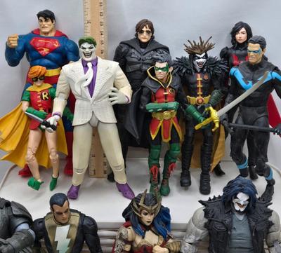 LOT 80: Large Variety of Action Figures Including Superman, Robin, Green Lantern, Many Anti-Heroes, and More