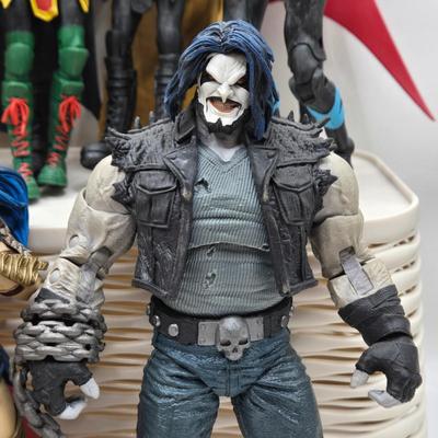 LOT 80: Large Variety of Action Figures Including Superman, Robin, Green Lantern, Many Anti-Heroes, and More