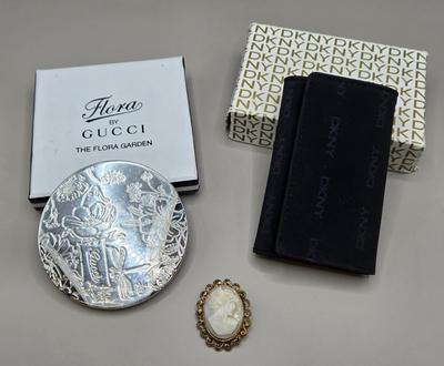 LOT 212J: Gucci Mirror Compact, DKNY Key Holder, and Cameo Brooch