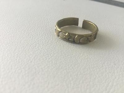 Gold tone unmarked star and moon ring