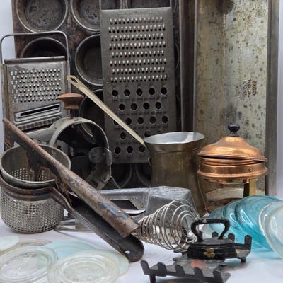 LOT 36: Vintage Kitchen Gadgets Including Hand Held Ice Crusher, Potato Masher, Cheese Graters, Can Opener, and More