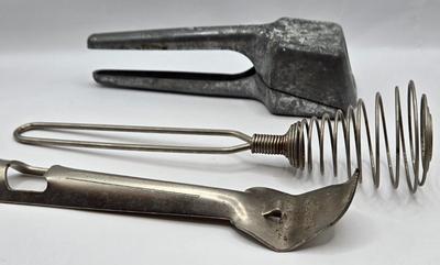 LOT 36: Vintage Kitchen Gadgets Including Hand Held Ice Crusher, Potato Masher, Cheese Graters, Can Opener, and More
