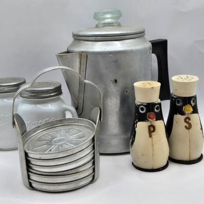 LOT 37: Kitchen Cabinet Lot Including Salt and Pepper Shakers, Vintage Coffee Pot, Coasters, Mortar and Pestle, and More