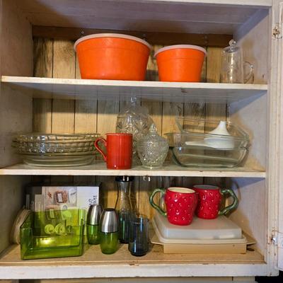 LOT 38: Kitchen Cabinet Lot: Tupperware Egg Tray, Avocado Green Napkin Holder & Salt/Pepper Shakers Strawberry Mugs, Glass Pie Pans,...