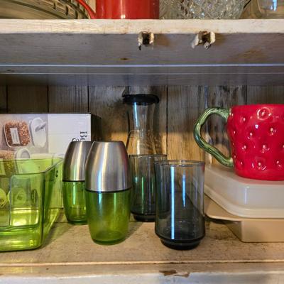 LOT 38: Kitchen Cabinet Lot: Tupperware Egg Tray, Avocado Green Napkin Holder & Salt/Pepper Shakers Strawberry Mugs, Glass Pie Pans,...