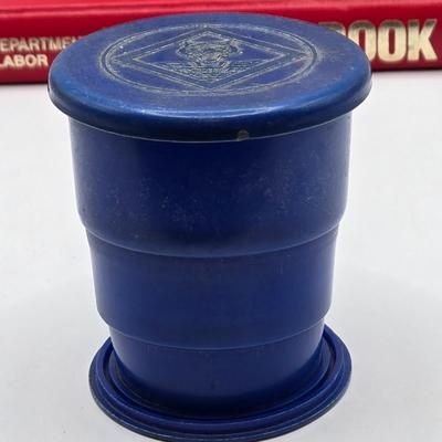 LOT 111: Cub Scout Book, First Aid Book, Boy Scout Patches, GI Joe Pocket Knife, Collapsible Cup, and More