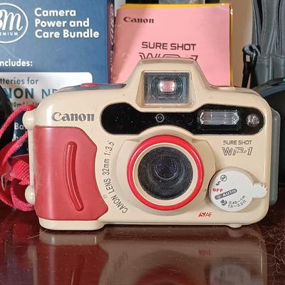 LOT 149: Canon Sure Shot WP-1, Canon NB-6LH Compatible Batteries, Quantaray Tripod & More